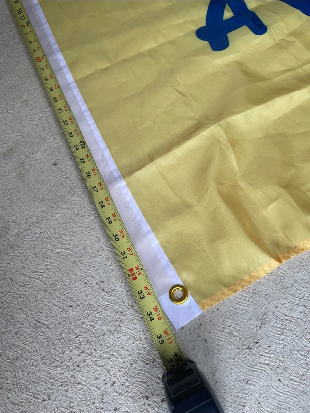 Play Like a Champion Today Yellow Banner with Blue Lettering and Grommet